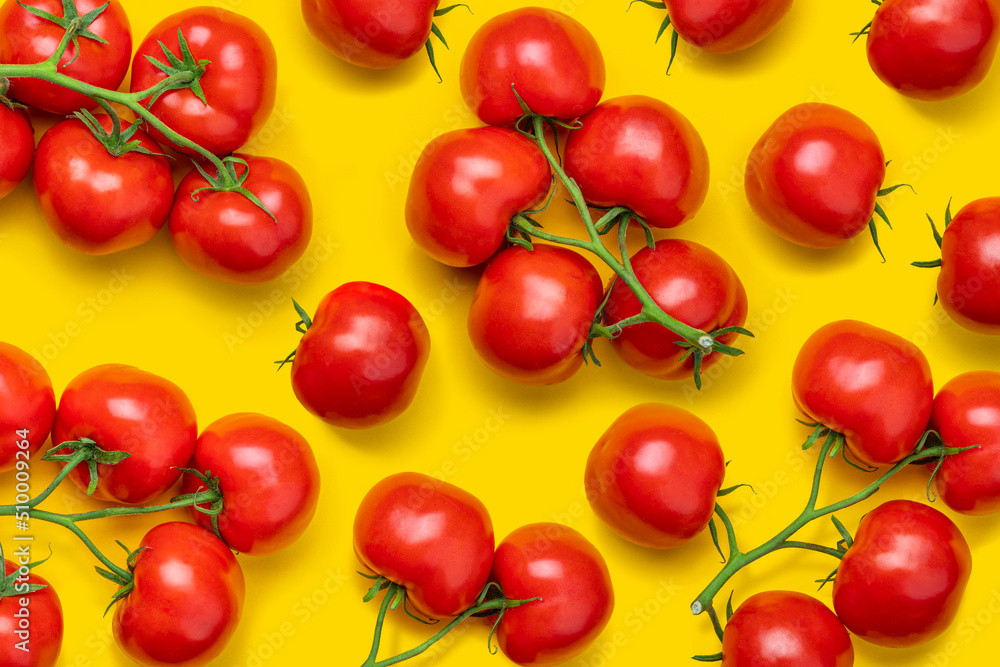 Tomato on a branch sprout top view flatlay on a yellow background. Fresh juicy ripe tomato Red Cherry fruits. Salad preparation ingredients. Pattern Tomato on a branch sprout top view flatlay on a yellow background. Fresh juicy ripe tomato Red Cherry fruits. Salad preparation ingredients. Pattern