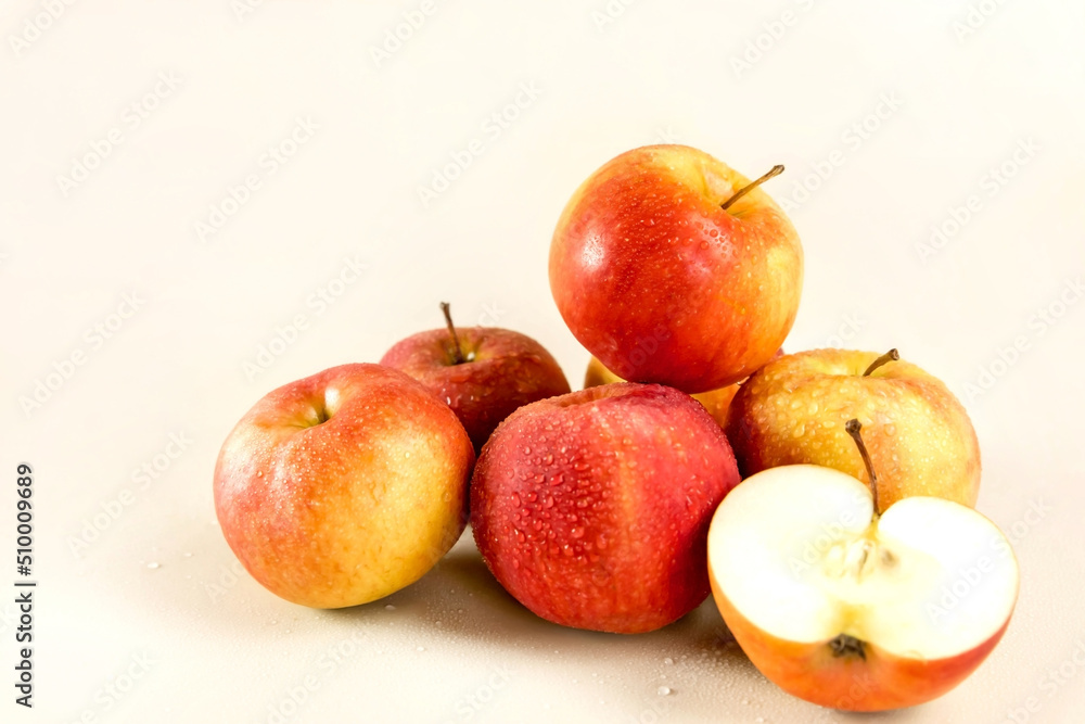 A bunch of red apples on a light background. cut apple A bunch of red apples on a light background. cut apple