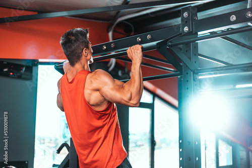 Male Athlete Doing Pull Ups - Chin Ups In The Gym. Copy Space