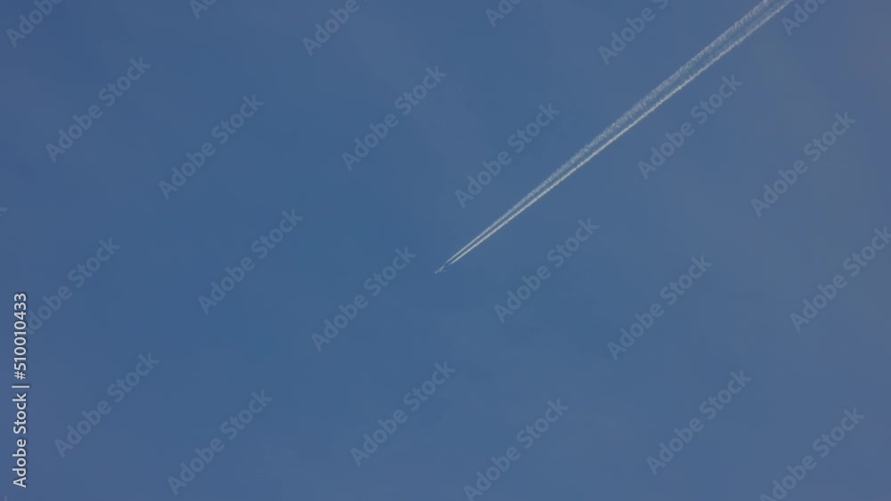 aircraft is making clouds as it flies over the blue sky. aircraft is making clouds as it flies over the blue sky.