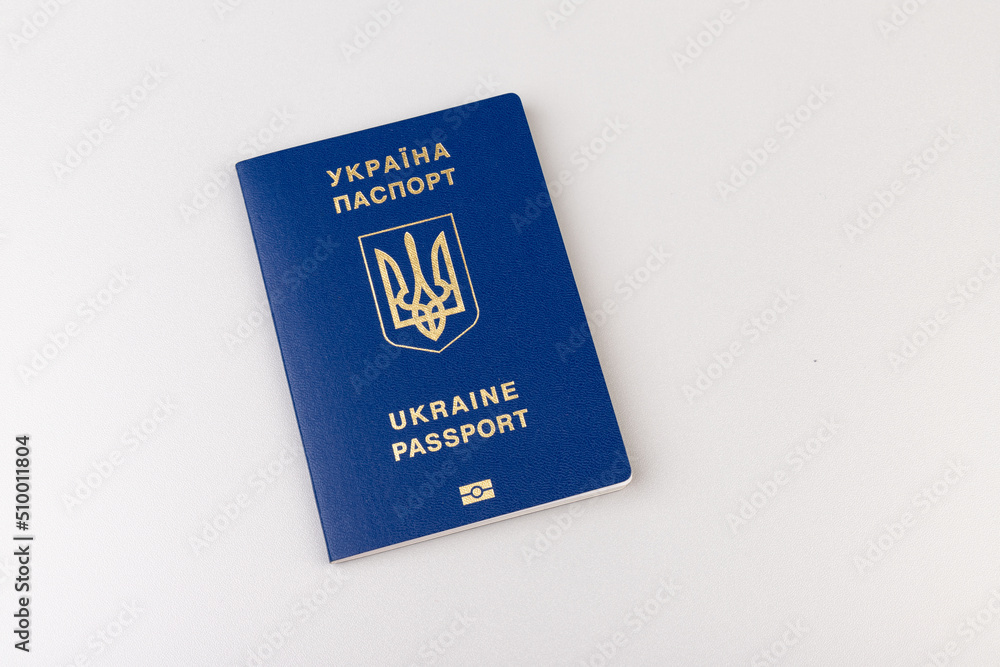 Ukrainian passport with a golden trident symbol on light background. Biometric Ukraine passport id empty place for photo or text. Ukrainian passport with a golden trident symbol on light background. Biometric Ukraine passport id empty place for photo or text.