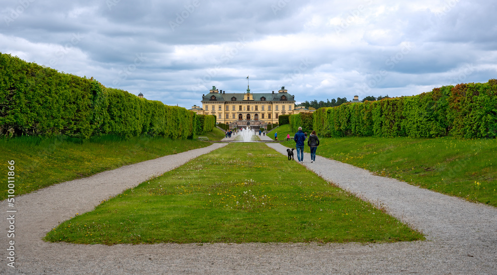 symmetric path at the park of palace Drottningholm with view onto the central axis in spring, Sweden