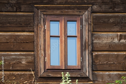 A wooden window in the church, an antique window, an old window frame and old panes. A beautiful, intimate facility, all built of wood. It was established many years ago.
