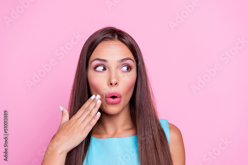 Photo of shocked impressed woman wear turquoise dress arm cheek looking empty space isolated pink color background