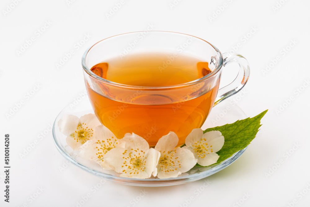 Composition with cup of jasmine tea and flowers on light background Composition with cup of jasmine tea and flowers on light background