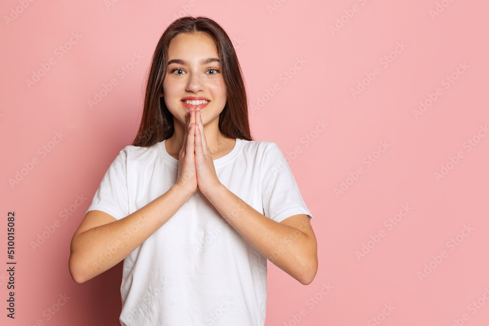 Half-length portrait of young pretty girl in white t-shirt isolated on pink background. Concept of beauty, art, fashion, youth and emotions Half-length portrait of young pretty girl in white t-shirt isolated on pink background. Concept of beauty, art, fashion, youth and emotions