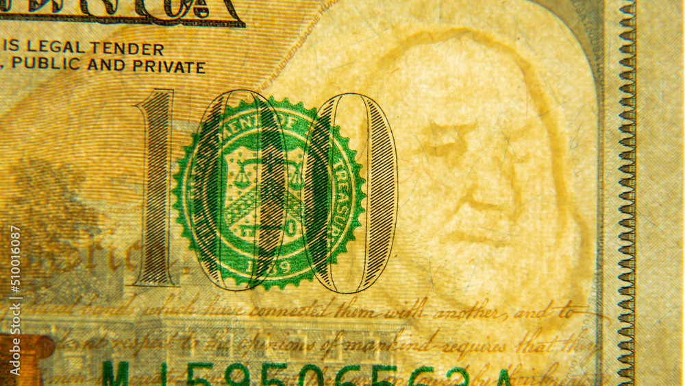 One hundred US dollars close-up with watermark. 