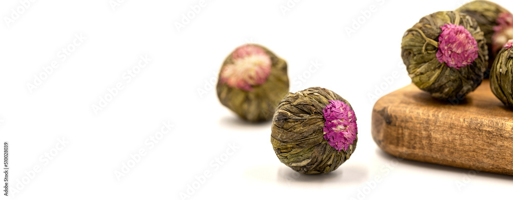 Jasmine tea balls isolated on white background. Flowering tea or blooming tea. close up. Copy space. Space for text Jasmine tea balls isolated on white background. Flowering tea or blooming tea. close up. Copy space. Space for text