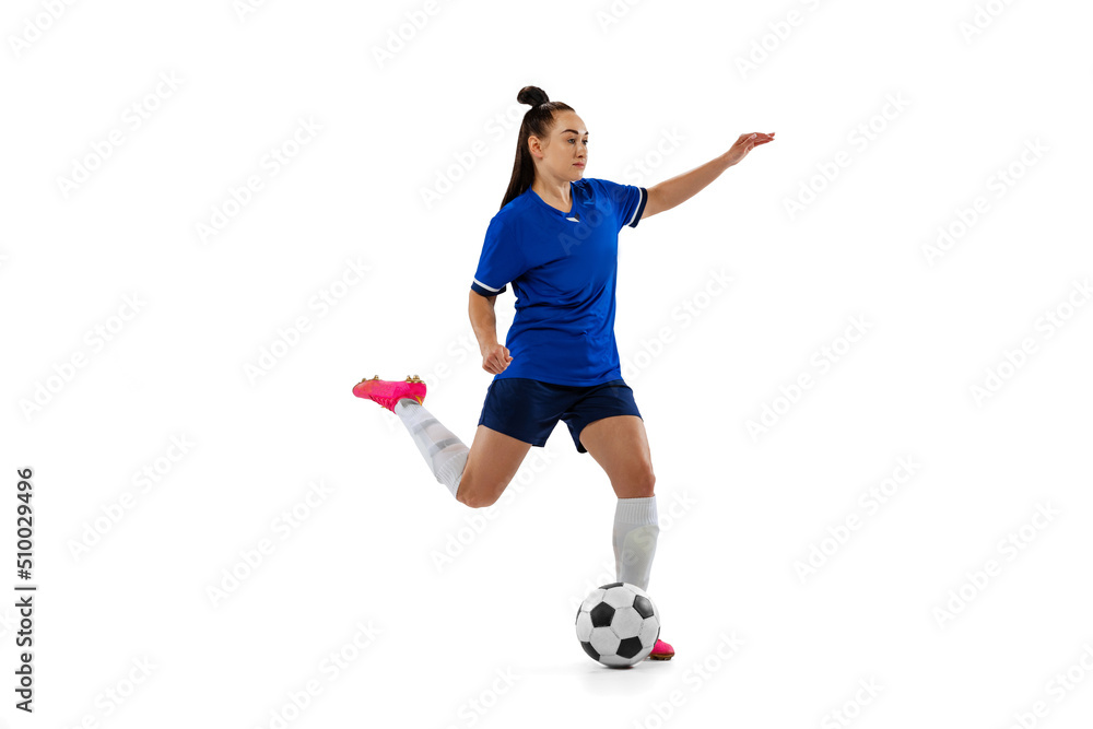 Fototapeta premium One sportive girl, female soccer, football player training isolated on white studio background. Sport, action, motion, fitness concept
