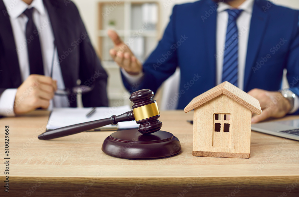 Lawyer and client make agreement of house mortgage during negotiations in office. Home model and barrister forefront. Taking lease and signing deal at law advisor cabinet. Lawyer and client make agreement of house mortgage during negotiations in office. Home model and barrister forefront. Taking lease and signing deal at law advisor cabinet.