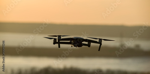 Quadcopter with a camera in flight. Technique for aerial photography