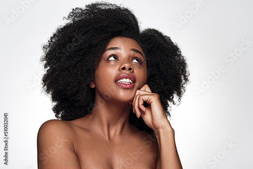 Hesitant black woman looking up