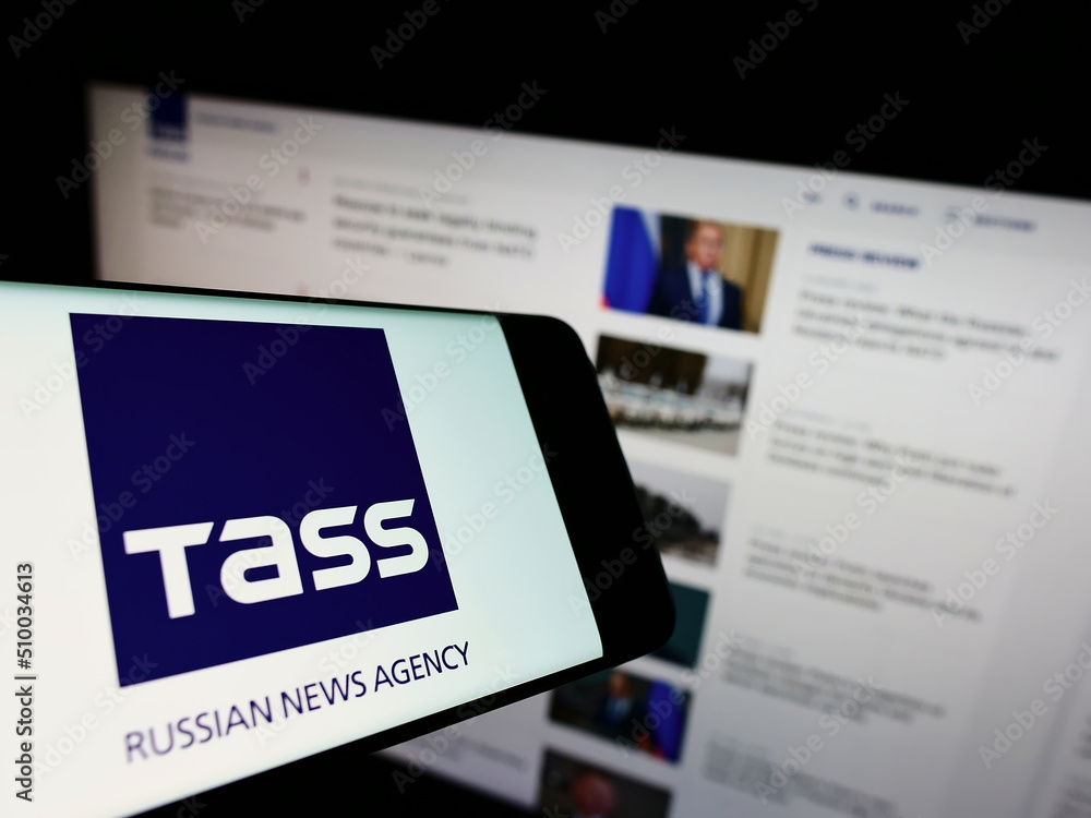 Stuttgart, Germany - 02-26-2022: Cellphone with logo of Russian news agency  TASS (TACC) on screen in front of business website. Focus on center-right  of phone display. Photos | Adobe Stock