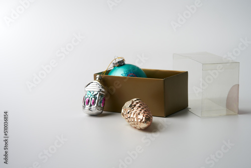 A box with family rarity Christmas tree toys on a white background. Copy space.