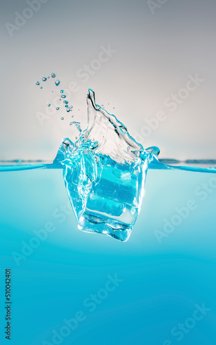 object falling into blue water until splashing on a gray background, freshness, nature, blurry objects
