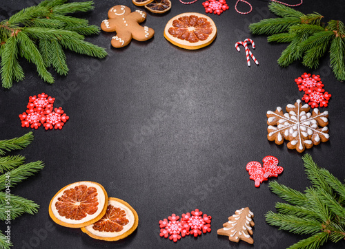 Festive Christmas table with appliances, gingerbreads, tree branches and dried citrus trees