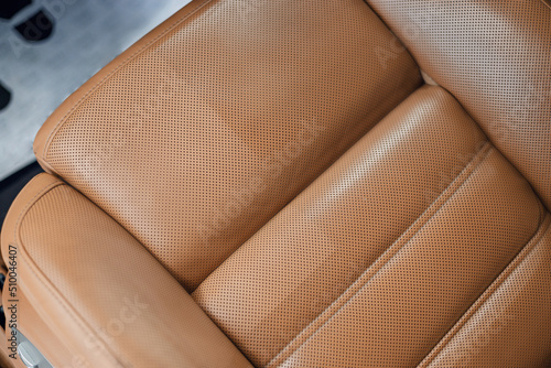Brown leather car seat after chemical treatment. Car detailing interior. Car interior leather seats professionally chemical cleaning. Regular clean up. Before/after comparison