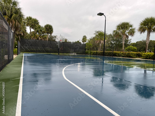 wet full court basketball background long view with street lights and hoop photo