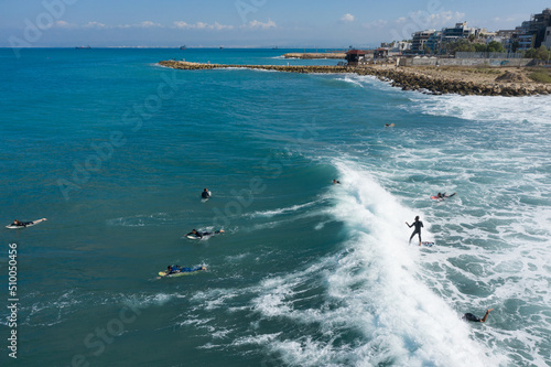 Haifa / Israel - Oct 30 2020 Drone view of surfer raiding a wave  in Bat Galim Haifa, surf time.