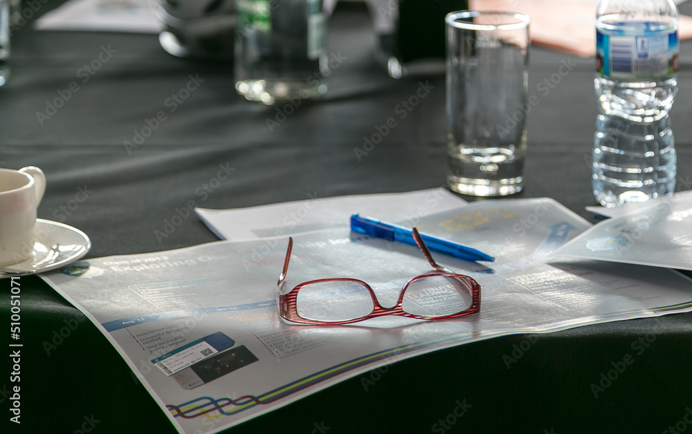 Close up of a businesswoman's spectacles on a conference table