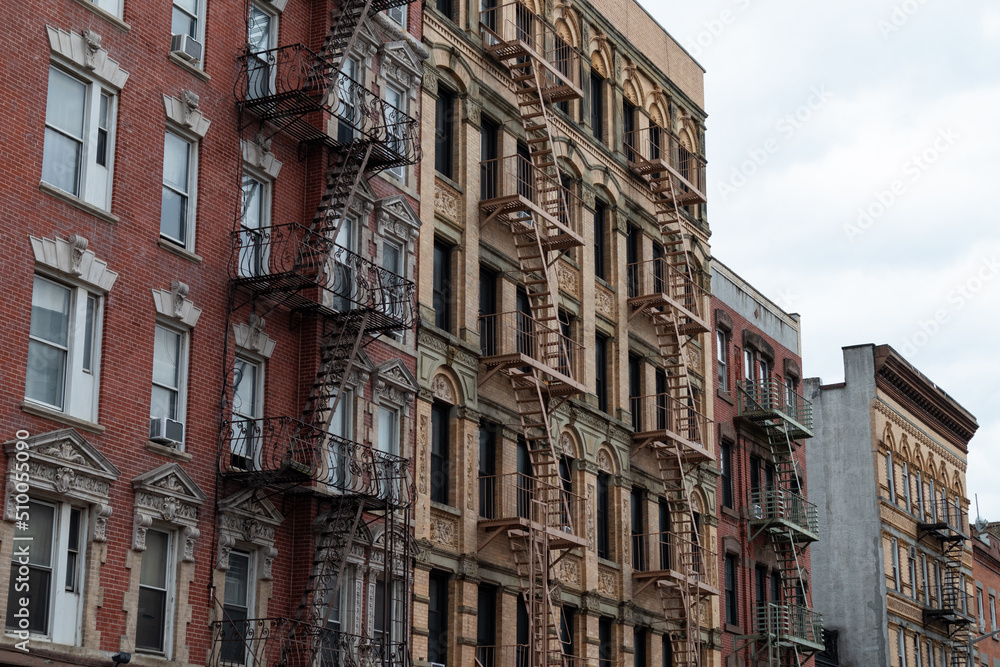 Row of Old Brick Apartment Buildings in Greenwich Village of New York City with Fire Escapes