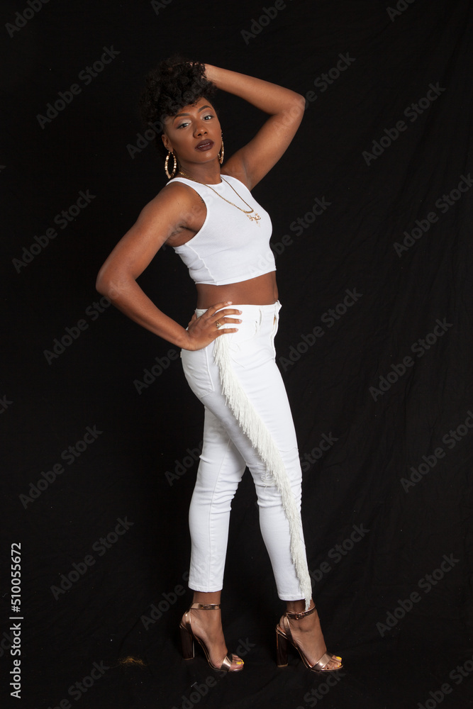 Lovely black woman in a white outfit looking pensive