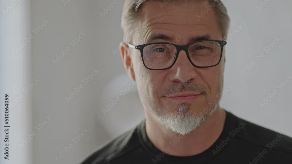 Portrait of mature age, middle age, mid adult casual man, happy smiling. Glasses, gray hair beard. Portrait of mature age, middle age, mid adult casual man, happy smiling. Glasses, gray hair beard.