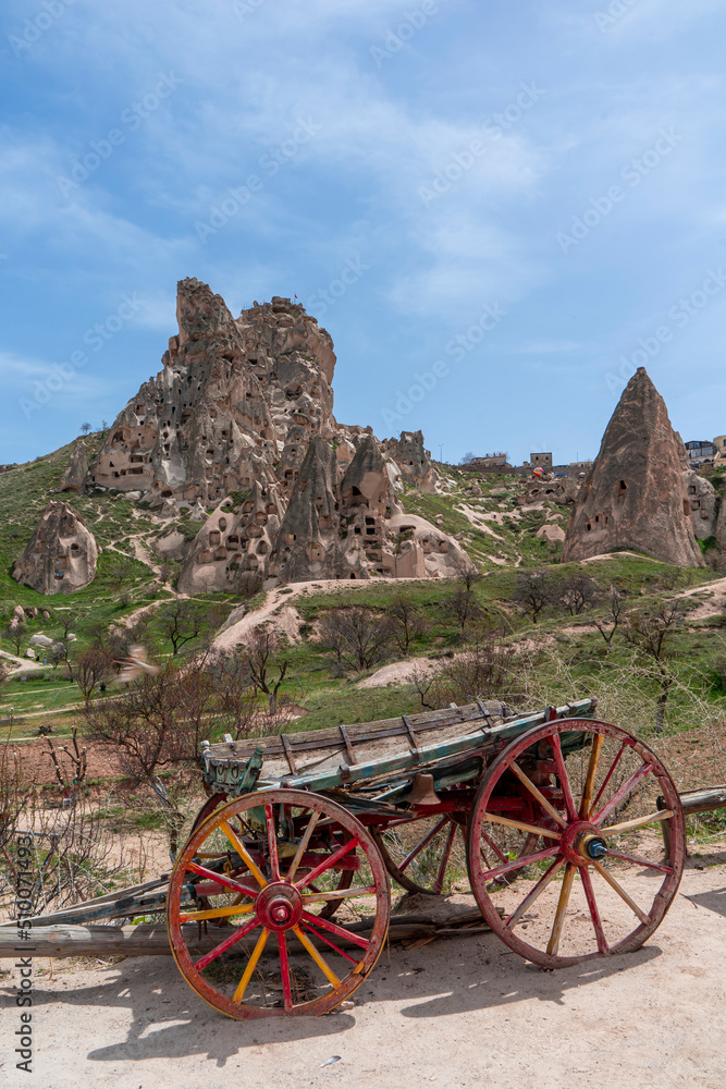 Horse carriage in the Pigeon Valley with Uchisar castle and walking road on the background. Cappadocia, Nevsehir, Turkey. 