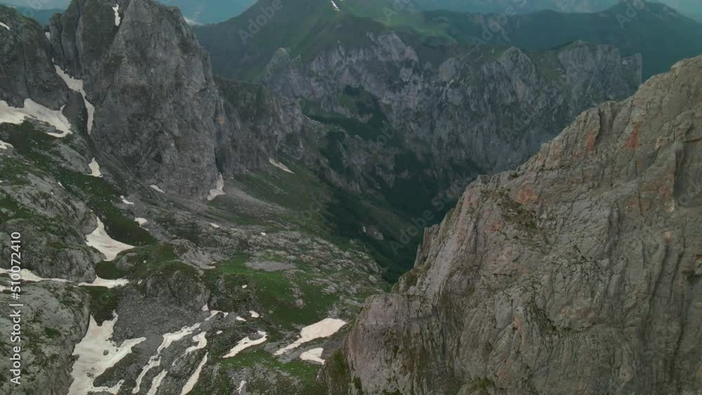 Aerial view of mountain valley in the Albanian Alps. Drone moving forward rising camera up Aerial view of mountain valley in the Albanian Alps. Drone moving forward rising camera up