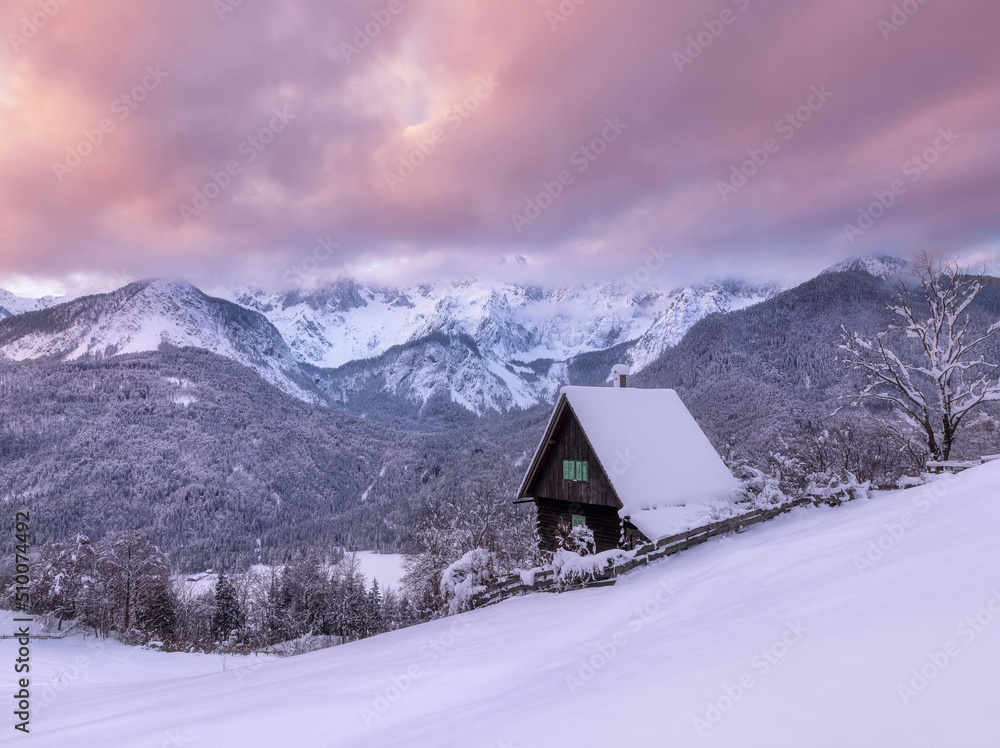 Cottage in the winter under the mountains