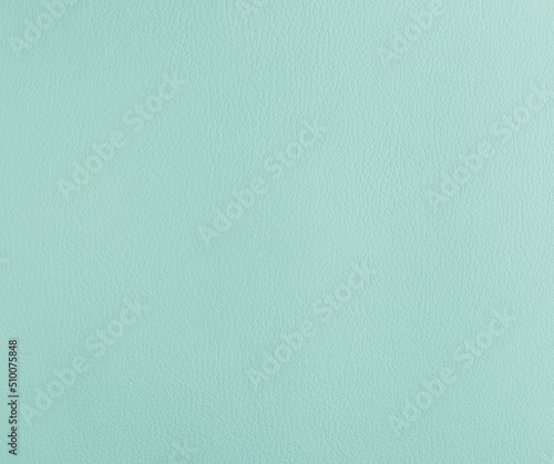 Piece of leatherette turquoise, texture, close-up, empty neutral plain background