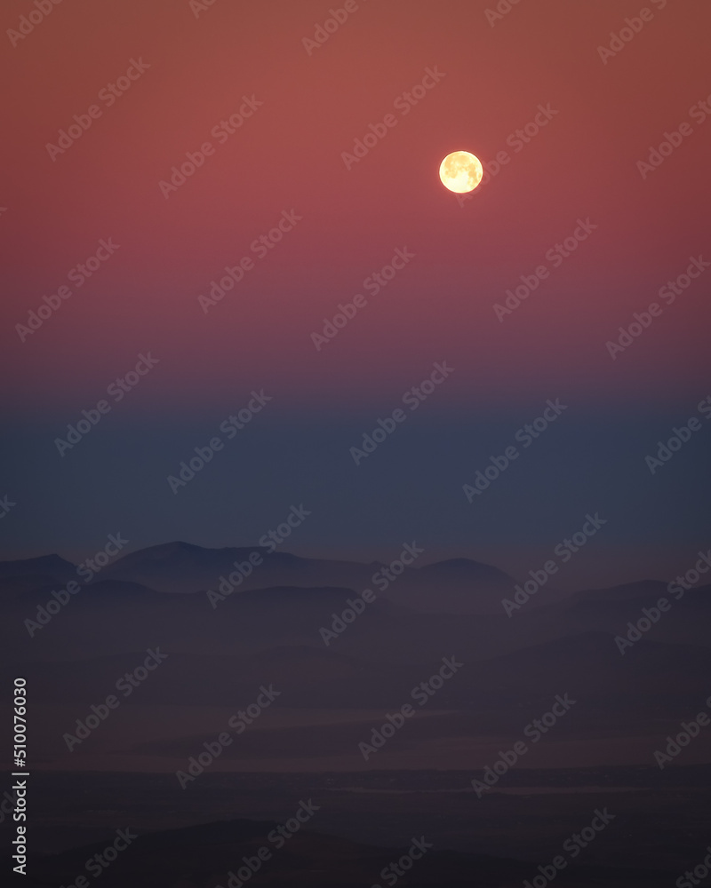 Amazing night scape with a moon with mountains