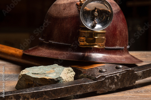 Old time antique vintage miners helmet with brass lantern rock stone turquoise pick
