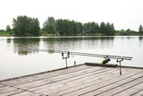 wooden pier and spinnings on big lake in Europe