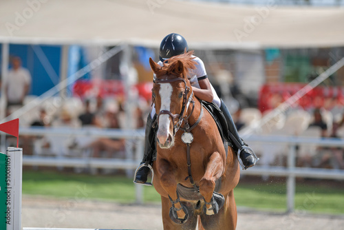 The rider on horseback overcomes the obstacle during the equestrian event © PROMA