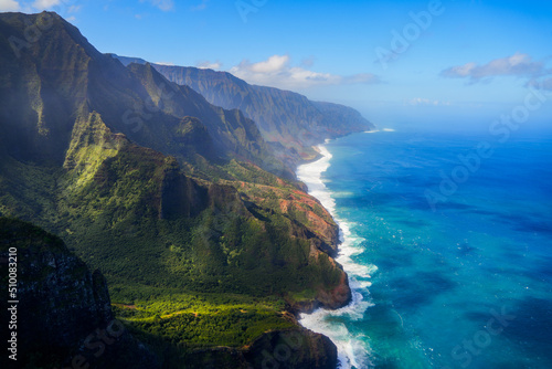 Aerial view of the dramatic ridges of the Na Pali coast, looming over the Pacific Ocean on the northwestern side of Kauai island in Hawaii