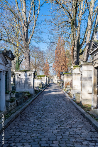 Paris, the Pere-Lachaise cemetery, cobbled alley with graves in winter 