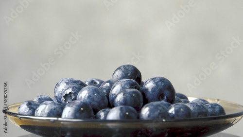 wild blueberries. Ecological product. Good for your health. Wild berry. Ingredient for jam. Berries on a glass saucer. Close-up. 