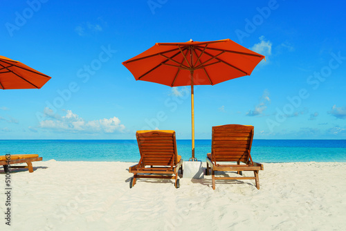  Two Chairs And Parasol With In The white Beach