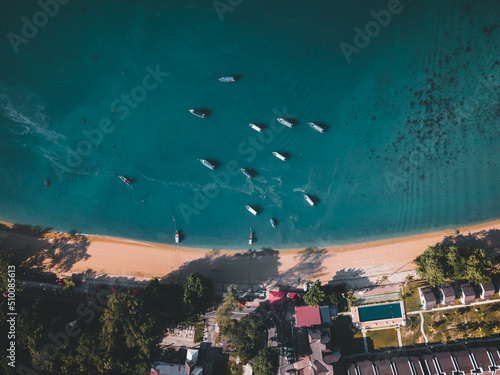 Boats docked by the beach on Pangkor island photo