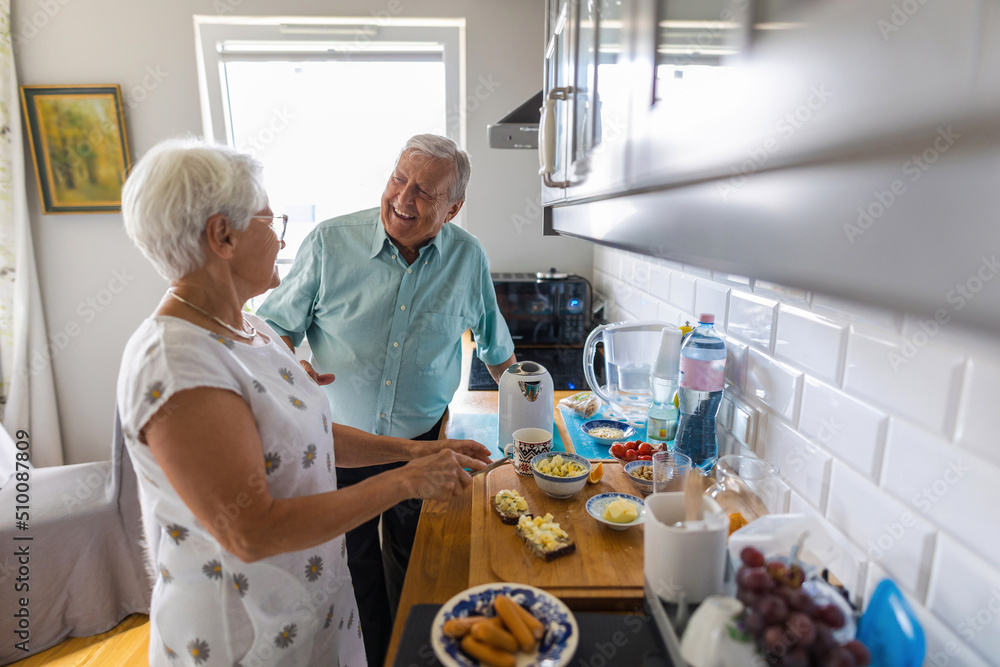 Senior couple in a kitchen making breakfast 
