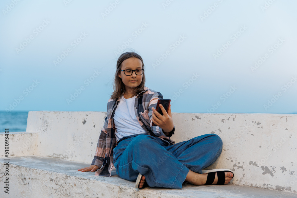 Teenage girl takes a selfie on the beach