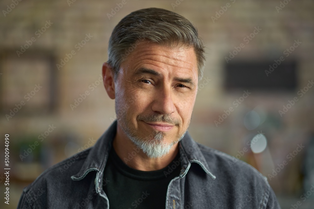 Fototapeta premium Happy middle aged good looking casual man at home, smiling. Portrait of mid adult, mature age man in glasses,