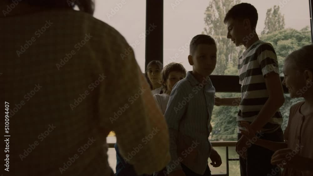 Aggressive students pushing conflict victim in hallway. Bullies insulting boy. Aggressive students pushing conflict victim in hallway. Bullies insulting boy.