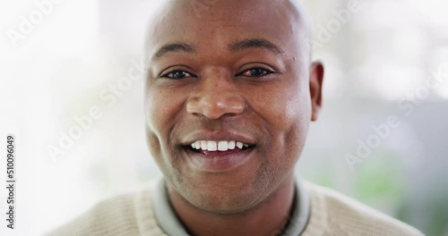 Portrait of one mature African American man with a bright smile and deep dimples looking content and attentive against bright copyspace background. Happy black man with natural white and healthy teeth photo