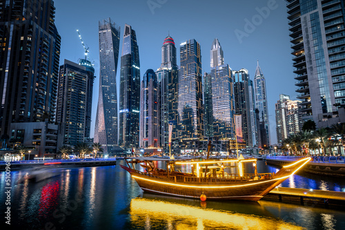 Obraz na płótnie Modern glass skyscrapers in Dubai with blue sky in background. Impressive architecture of financial district and Dubai marina. w salonie