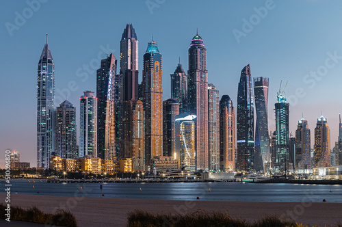 Photography Modern glass skyscrapers in Dubai with blue sky in background
