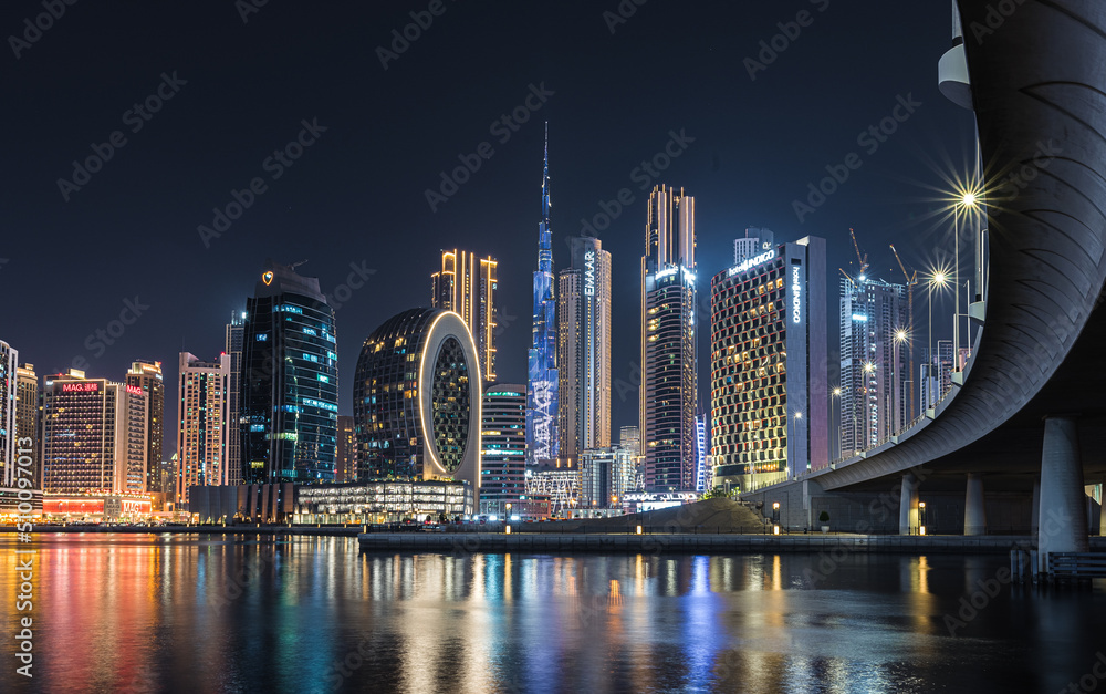 Modern glass skyscrapers in Dubai with blue sky in background. Impressive architecture of financial district and Dubai marina.