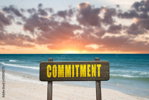 Commitment sign in nature at the beach.