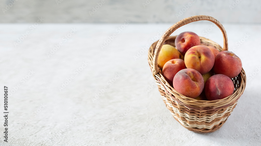 Ripe peaches in a basket, banner with copy space, close-up Ripe peaches in a basket, banner with copy space, close-up
